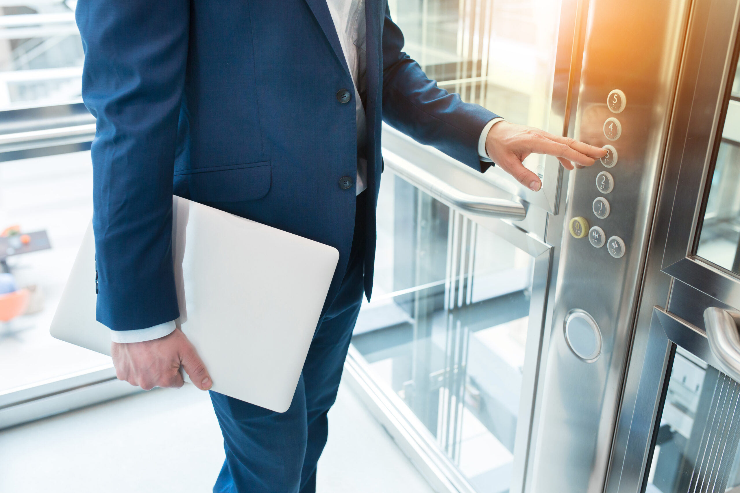 Men finger presses the elevator button. Businessman is a lift. high floor