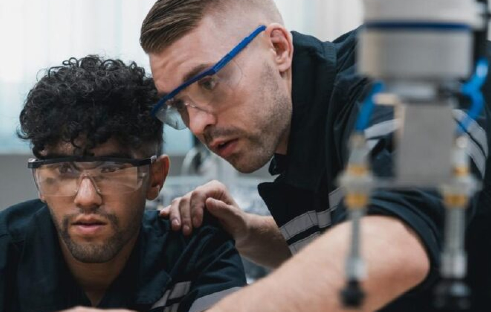 Two technicians working on a machine